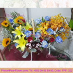 Mixed cut flowers basket of lily, rose & orchid
