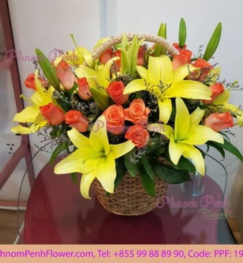 Yellow lily with orange rose basket