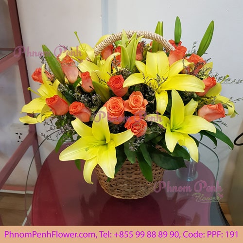 Yellow lily with orange rose basket